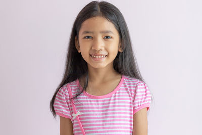 Portrait of a smiling girl over white background