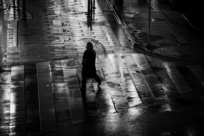 High angle view of silhouette woman walking on floor