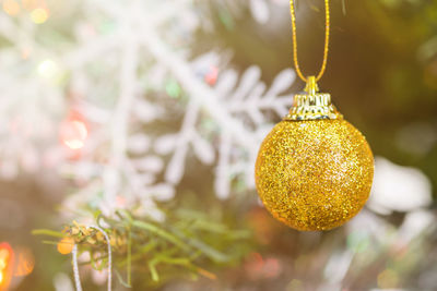 Close-up of christmas decorations hanging on tree