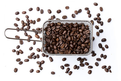 High angle view of coffee beans against white background