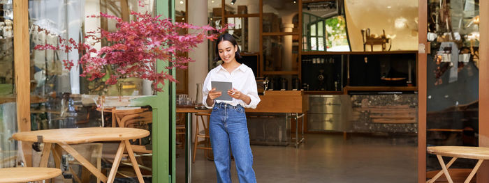 Side view of young woman sitting at home