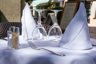 Close-up of wineglass with napkin on table at sidewalk cafe