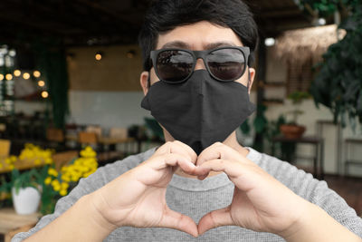 Close-up of man holding sunglasses