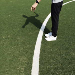 Low section of man standing on ground