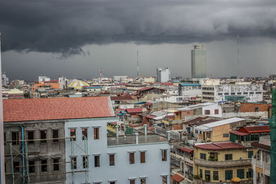 Cityscape against cloudy sky