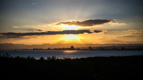 Scenic view of lake against romantic sky at sunset