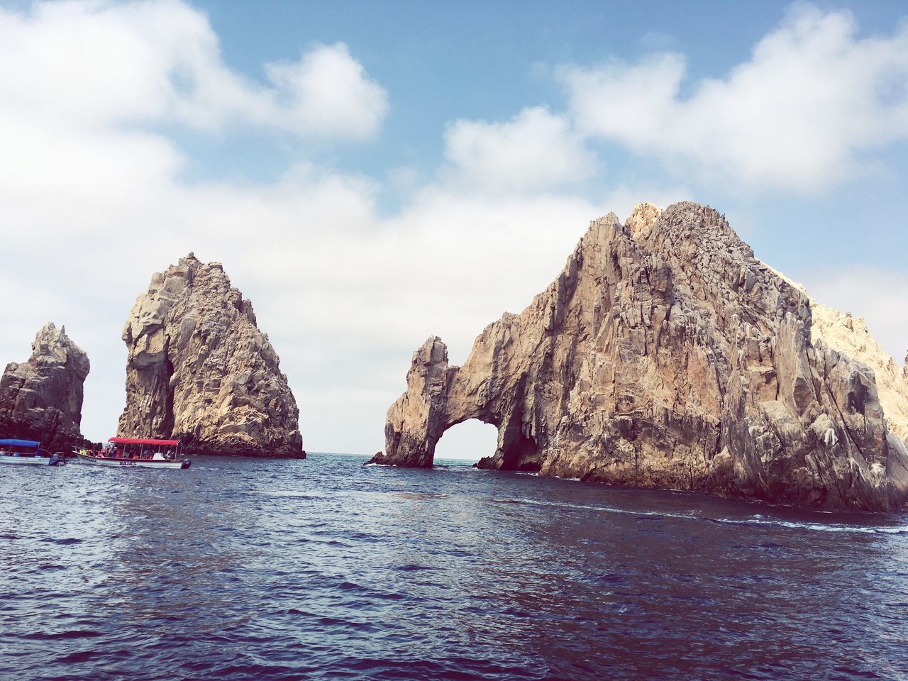 water, waterfront, sky, cloud - sky, scenics, tranquility, tranquil scene, rock - object, beauty in nature, sea, rippled, nature, rock formation, cloud, river, idyllic, day, cloudy, reflection, outdoors