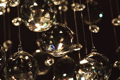 Close-up of disco balls hanging in darkroom