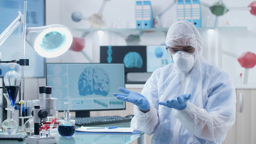 Rear view of scientist working in laboratory