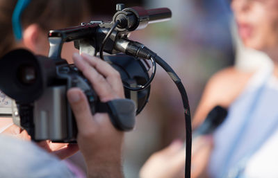 Journalist filming woman