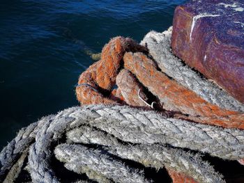 High angle view of rope tied on metal