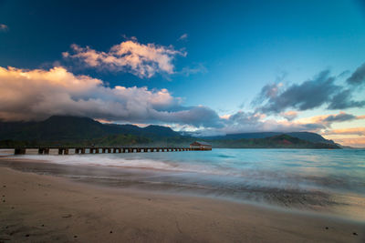 Scenic view of beach against sky during sunset