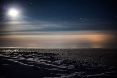 Scenic view of beach against sky at night