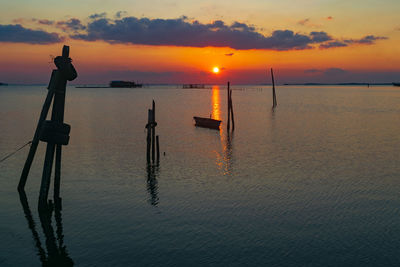 Scenic view of sea against orange sky