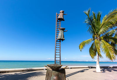 Lifeguard hut on beach against clear sky