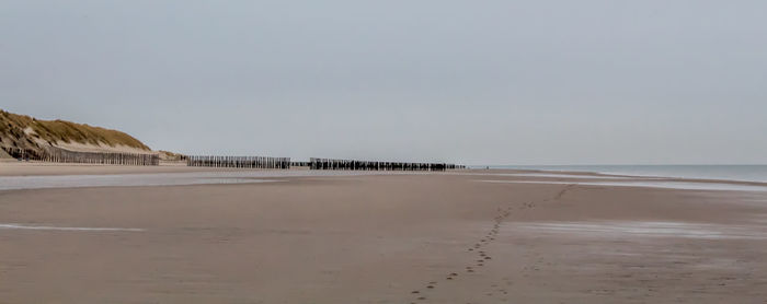 Scenic view of beach against clear sky