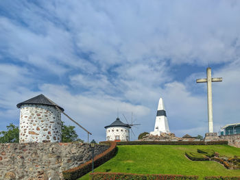 Lighthouse by sea against sky