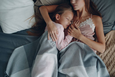 High angle view of woman lying on bed