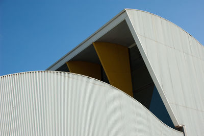 Modern office building against clear blue sky