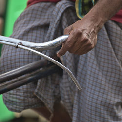 Midsection of man riding bicycle outdoors