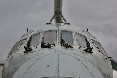 Low angle view of old airplane against sky