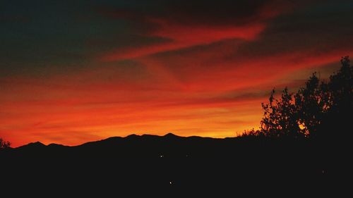 Silhouette of landscape against dramatic sky