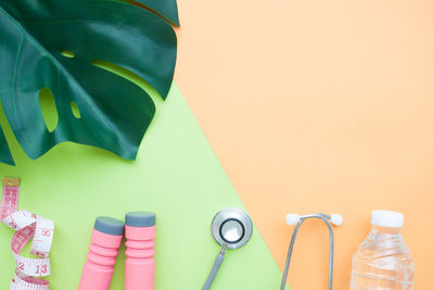 Directly above shot of leaf with medical and sports equipment on table