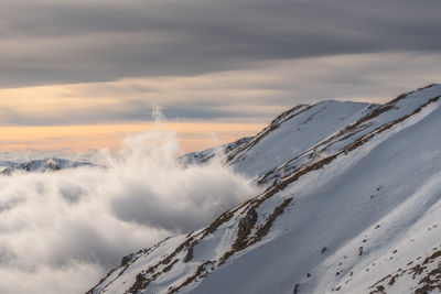 Scenic view of snowcapped mountains against sky during winter