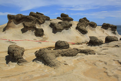 Rocks on landscape against the sky