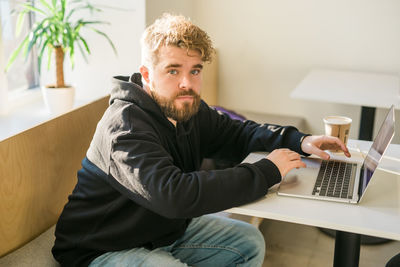 Young man using laptop at home