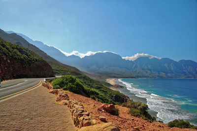 Scenic view of sea and mountains against sky