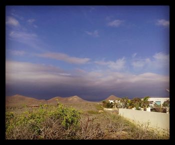 Scenic view of landscape against cloudy sky