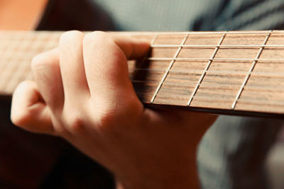 Close-up of hand playing guitar