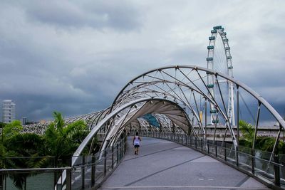 Bridge against cloudy sky