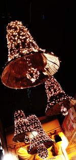 Low angle view of illuminated christmas lights at night