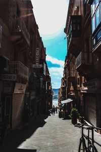 Street amidst buildings in city against sky