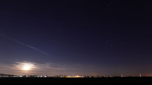 Low angle view of illuminated star field against sky at night