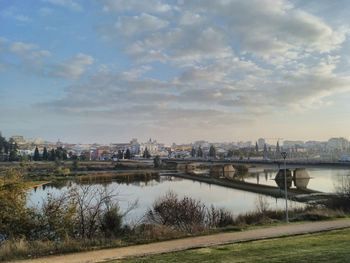 View of bridge over river against cloudy sky