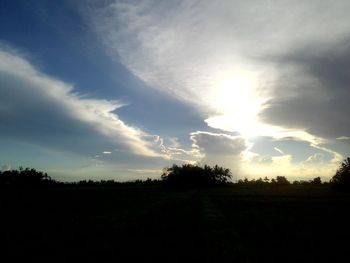 Scenic view of silhouette field against sky