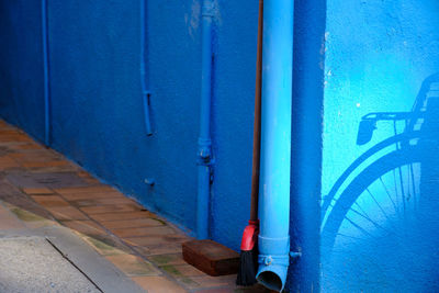 High angle view of bicycle against blue wall