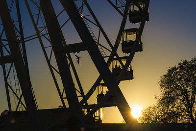 Low angle view of silhouette bridge against sky during sunset