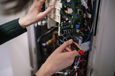Hands of engineer repairing router in server room
