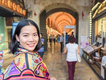 Portrait of smiling woman in city