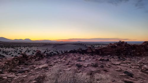 Scenic view of desert against sky during sunset