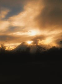 Scenic view of silhouette mountain against dramatic sky