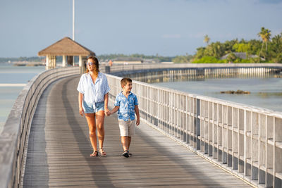 Mother and son on a runway holding hands