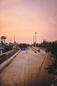 High angle view of road by buildings against sky during sunset