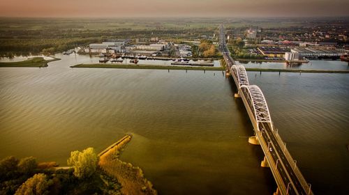 High angle view of river amidst buildings against sky