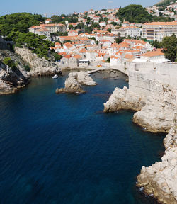 High angle view of townscape by sea