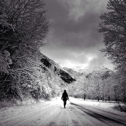 Woman walking on country road